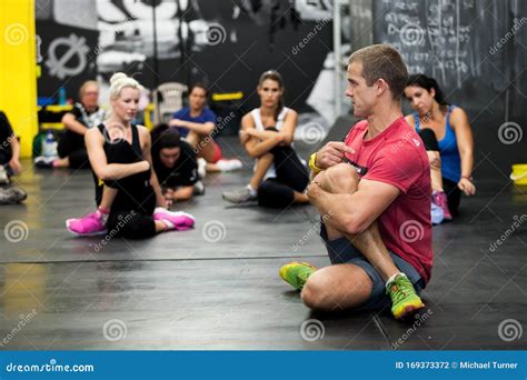 personal trainer giving fitness instruction at a crossfit group class