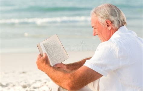 Man Reading A Book On The Beach Stock Image Image Of Elderly White