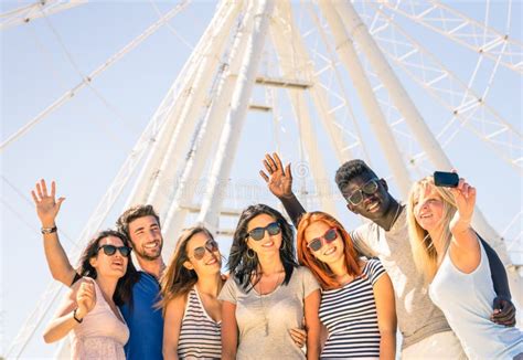 Group Of Multiracial Happy Friends Taking Selfie At Ferris Wheel Stock