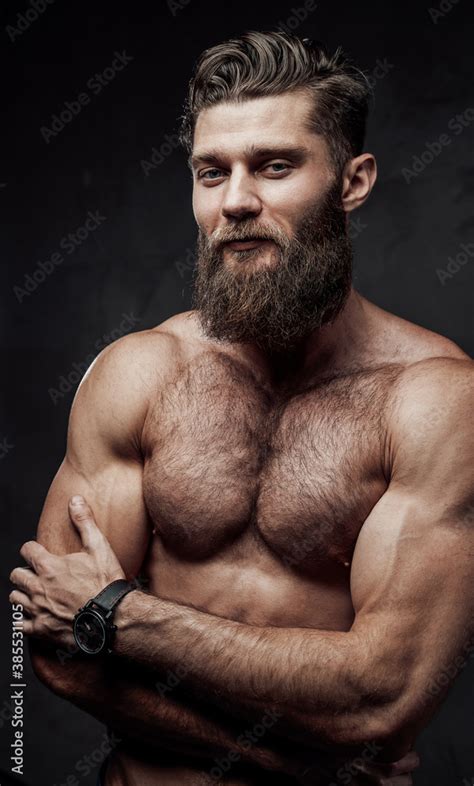Naked Man With Muscular Build And Beard Posing With Crossed Arms