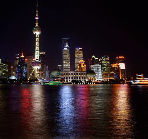 Bright Night Lights Of Pudong High Rise Towers Reflected In The