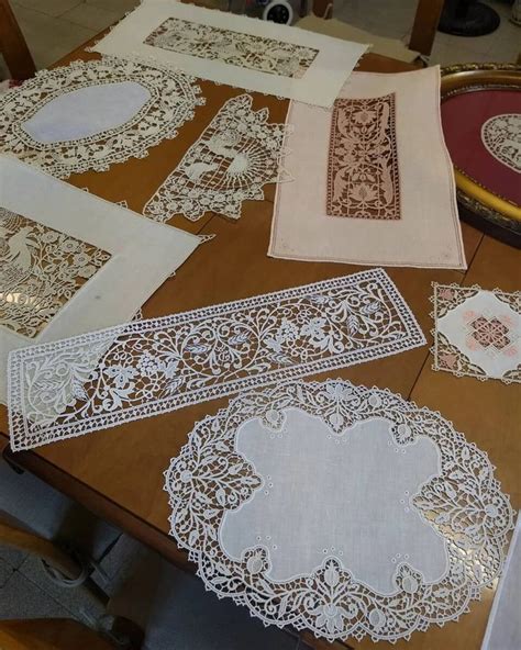Several Pieces Of Lace Laid Out On Top Of A Wooden Table With Other Doily
