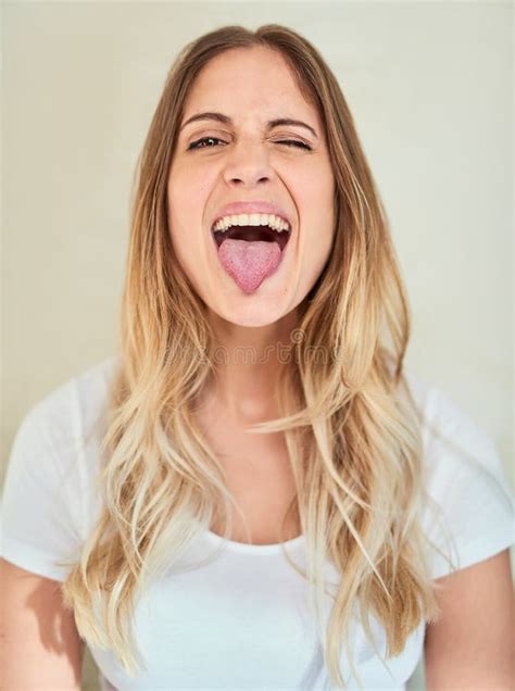 Lets Be Silly Together Portrait Of An Attractive Young Woman Sticking Out Her Tongue Stock