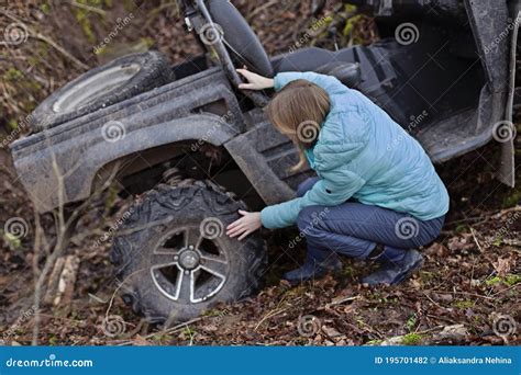 A Woman Checks the Tires of a Buggy that Has Rolled Down a Mountain