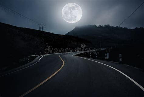 Landscape Of Nighttime With Curvy Roadway In Forest At National Stock