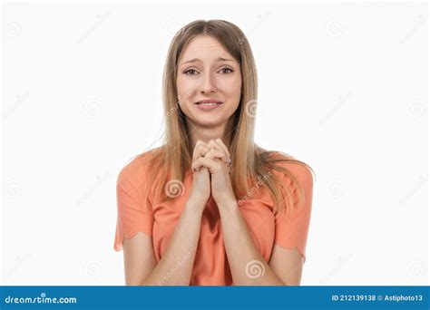 Portrait Of Dreamy Blond Girl Making Wish Clench Fists Close To Chest Praying Hopeful Luck