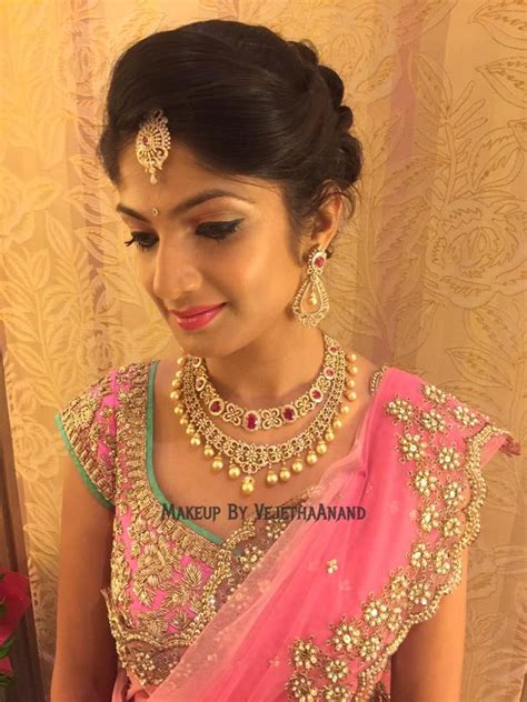 Rolled up and tucked in bun with puffy crown. Indian bride Akshata wears bridal lehenga and jewellery ...