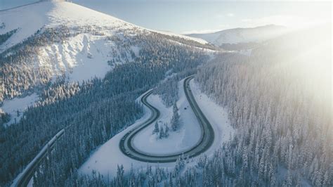 Aerial View Of Mountain Road And Snow Covered Mountain With Trees 4k Hd