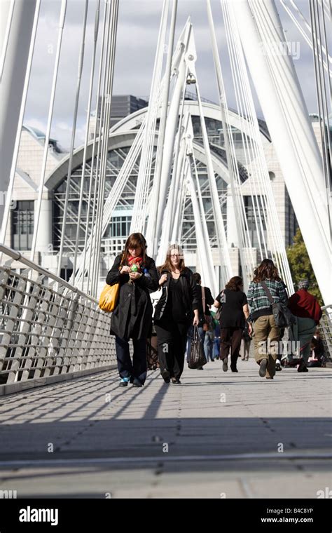 Pedestrians On Golden Jubilee Bridge Charing Cross Westminster London