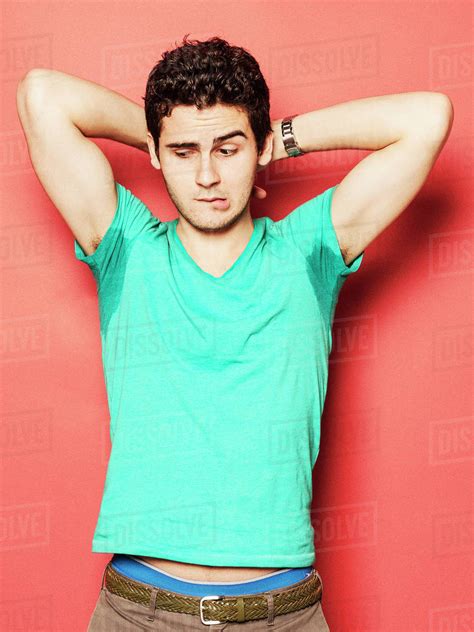 Babe Man Biting Lip While Looking At Sweaty Armpit Against Red Background Stock Photo Dissolve