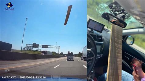 lumber flies off truck straight through woman s windshield youtube