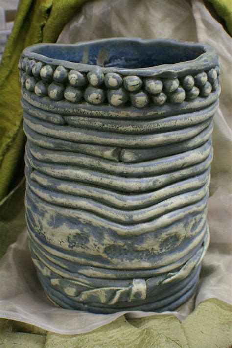 A Large Blue Vase Sitting On Top Of A Table