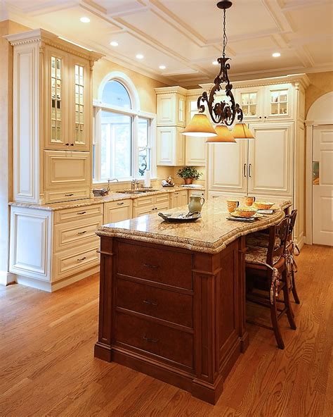 Kitchen cabinets with vaulted ceiling. Walnut Island against backdrop of painted cream color ...