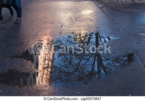 Rain Puddle On Sidewalk