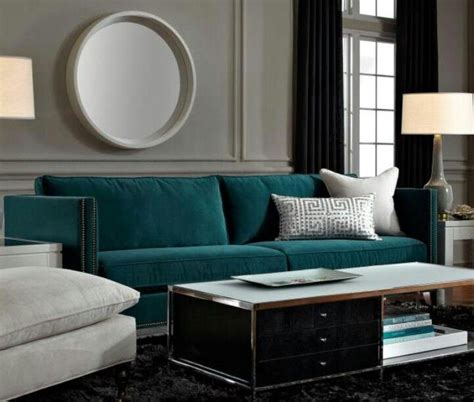 Teal living room ideas are what inspire us to break from the mould, moving away from the typical whites and greys often seen in the sitting room. Deep teal sofa is a gem against grey walls, a dark rug ...