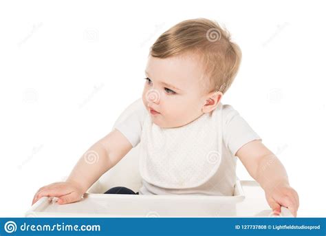 The baby can hold something in his hands: Adorable Baby Boy In Bib Sitting In Highchair Stock Photo ...