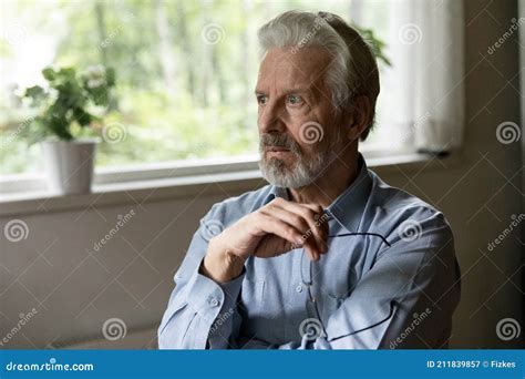 Pensive Older Man Holding Glasses And Looking Away Stock Image Image Of Alone Amnesia 211839857