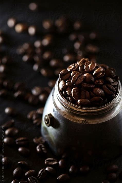 Coffee Beans Spilling Out Of A Pot On Top Of A Black Surface By Luke