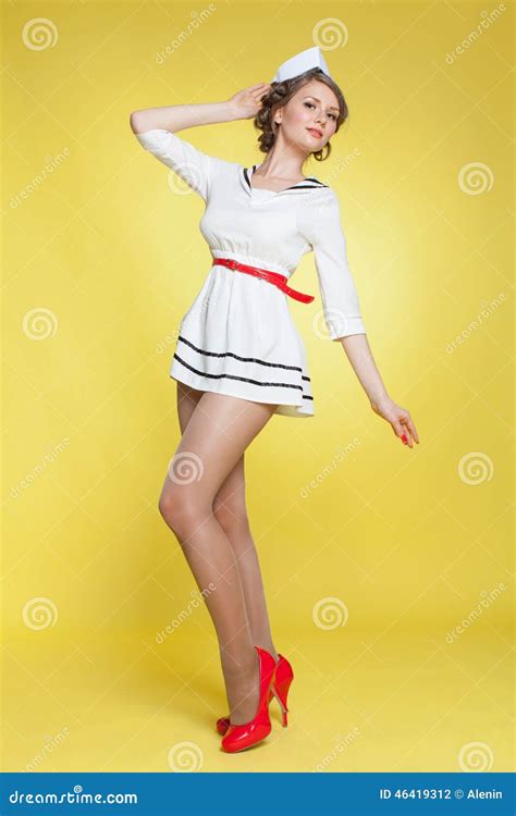 Beautiful Pin Up Girl Dressed A Sailor Posing On Yellow Background Wall