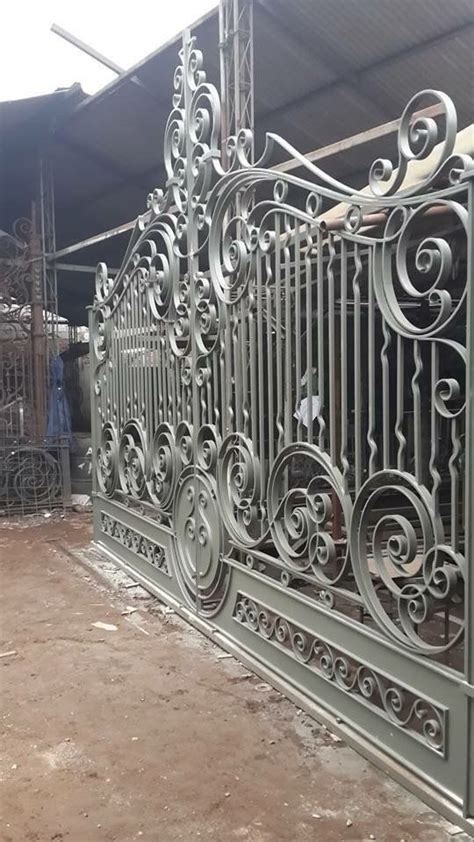 An Iron Gate Is Shown In Front Of A Building That S Being Built Into