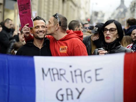 french president francois hollande signs gay marriage and same sex adoption into law despite