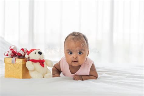 African Baby Newborn Is 3 Month Old Lying On The White Bed Stock Photo