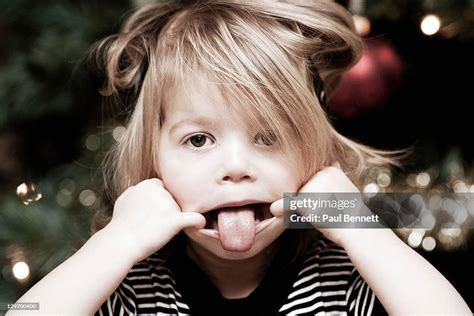 Girl Pulling Out Funny Face High Res Stock Photo Getty Images