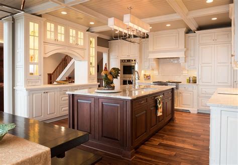 If you already have bold kitchen cabinetry, look to a contrasting wood finish to make your island stand out. Traditional White Kitchen with Dark Cherry Island ...