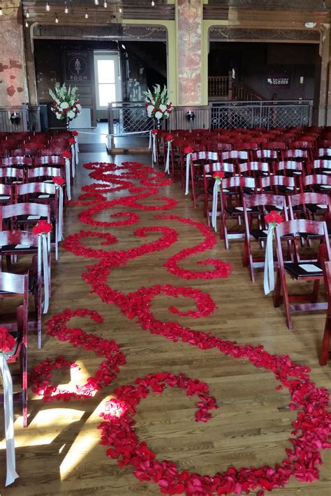 When planning your wedding reception decorations, be mindful of your space and how your centerpieces can complement it. Scrolling red rose petal aisle. Romantic and perfect for ...