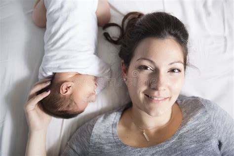 Happy Mother And Baby Lying On Bed At Home Stock Image Image Of
