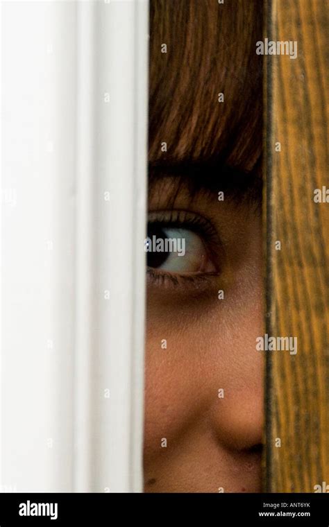 Teenage girl spying through a crack in a door. USA Stock Photo - Alamy