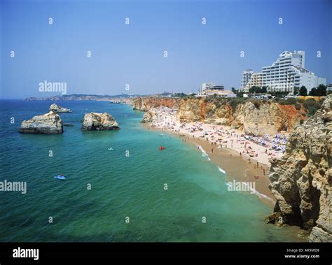 Hotels And Sunbathers On Mediterranean Beaches Along Praia Da Rocha In