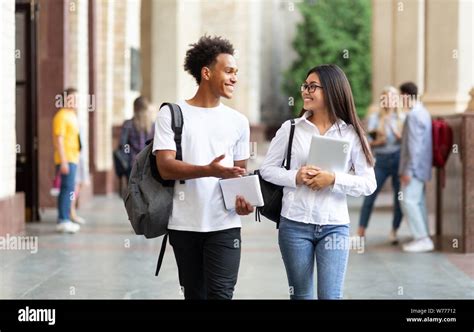 College Friends Walking In Campus And Talking Stock Photo Alamy