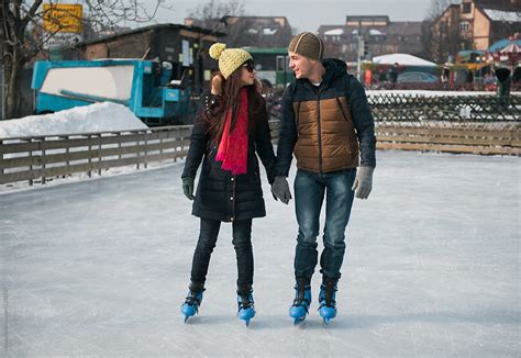 Couple Ice Skating And Holding Hands By Stocksy Contributor Mosuno