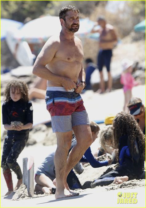 Gerard Butler Goes Shirtless While Hitting The Beach With Bikini Clad
