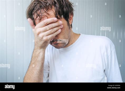 Sad And Blue Man Covering Face And Crying In Despair Stock Photo Alamy