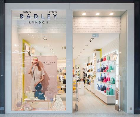 A Store Front With An Advertisement For Radley London On Its Glass Window