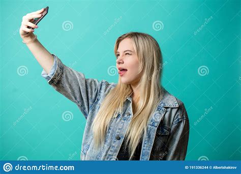 Positive Blond Haired Woman Taking Selfie On Isolated Blue Background