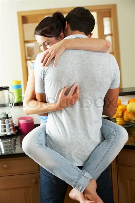 Romantic Couple Hugging In Kitchen Stock Photo Colourbox