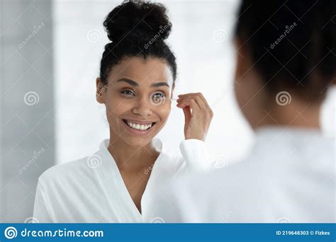 Happy Girl In Bathrobe Cleaning Ears With Cotton Swab Stock Image
