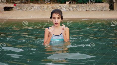 Happy Teen Girl Playing In The Sea Girl Happily Frolics On The Beach