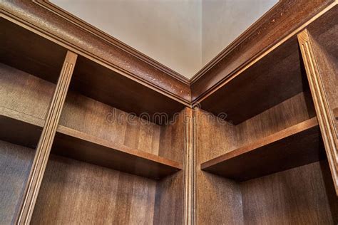 Wooden Bookcase With Empty Shelves And A Wooden Balustrade In Home