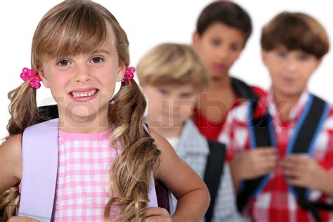 Schulmädchen mit Ranzen und Jungs im Hintergrund Stock Bild Colourbox