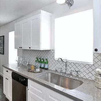 Kitchen backsplashes can be as simple as a 6 inch high piece of your countertop and as complex as an intricate tile design. White Arabesque Cooktop Tiles - Transitional - Kitchen