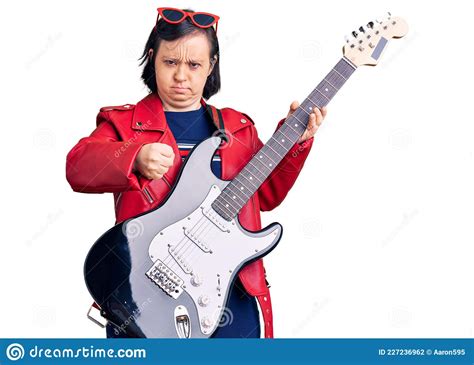 Brunette Woman With Down Syndrome Playing Electric Guitar Annoyed And