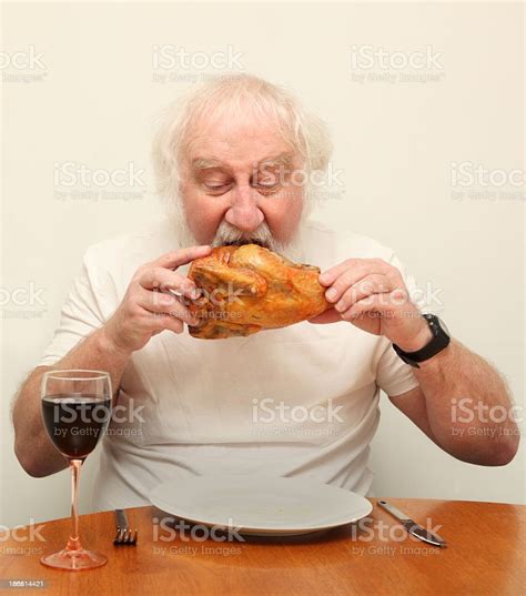 Greedy Senior Bearded Male Eating Whole Roast Chicken With Intensity