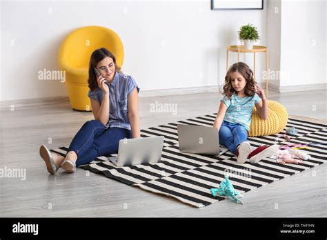 Busy Mother With Funny Daughter Working At Home Stock Photo Alamy