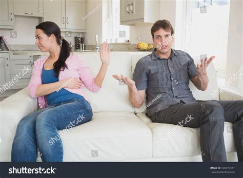 62'' loveseat, sofa couch for two people, with 2 pillows and flared arm, liner fabric, sky blue. Two People Sitting On The Couch In The Living Room While ...
