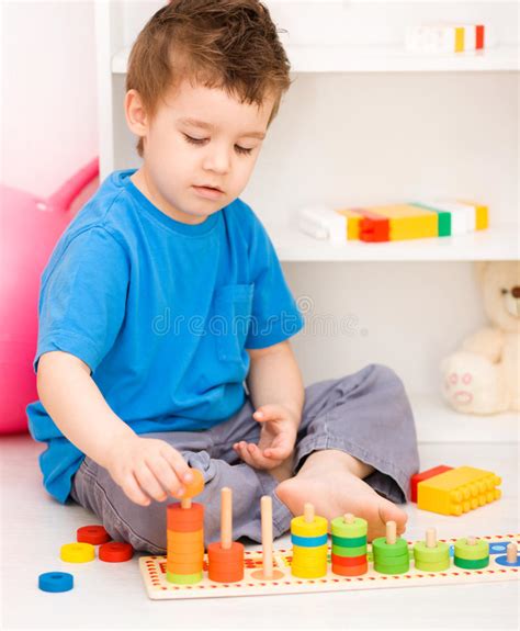 Boy Is Playing With Building Blocks Stock Photo Image Of Human