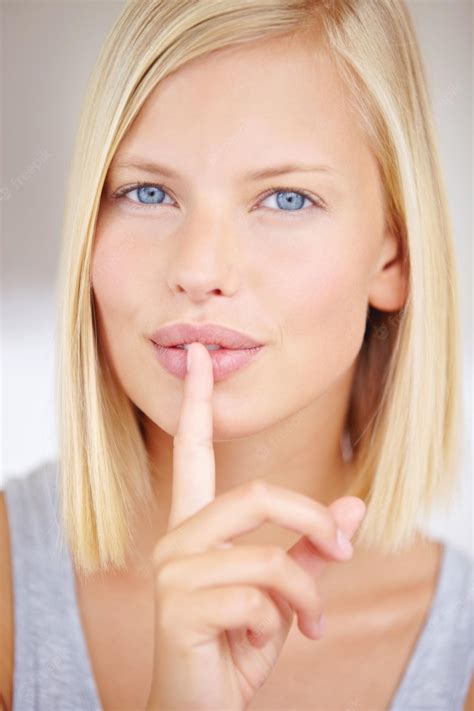 Premium Photo Ill Never Tell My Beauty Secrets Portrait Of A Young Woman Holding Her Finger In